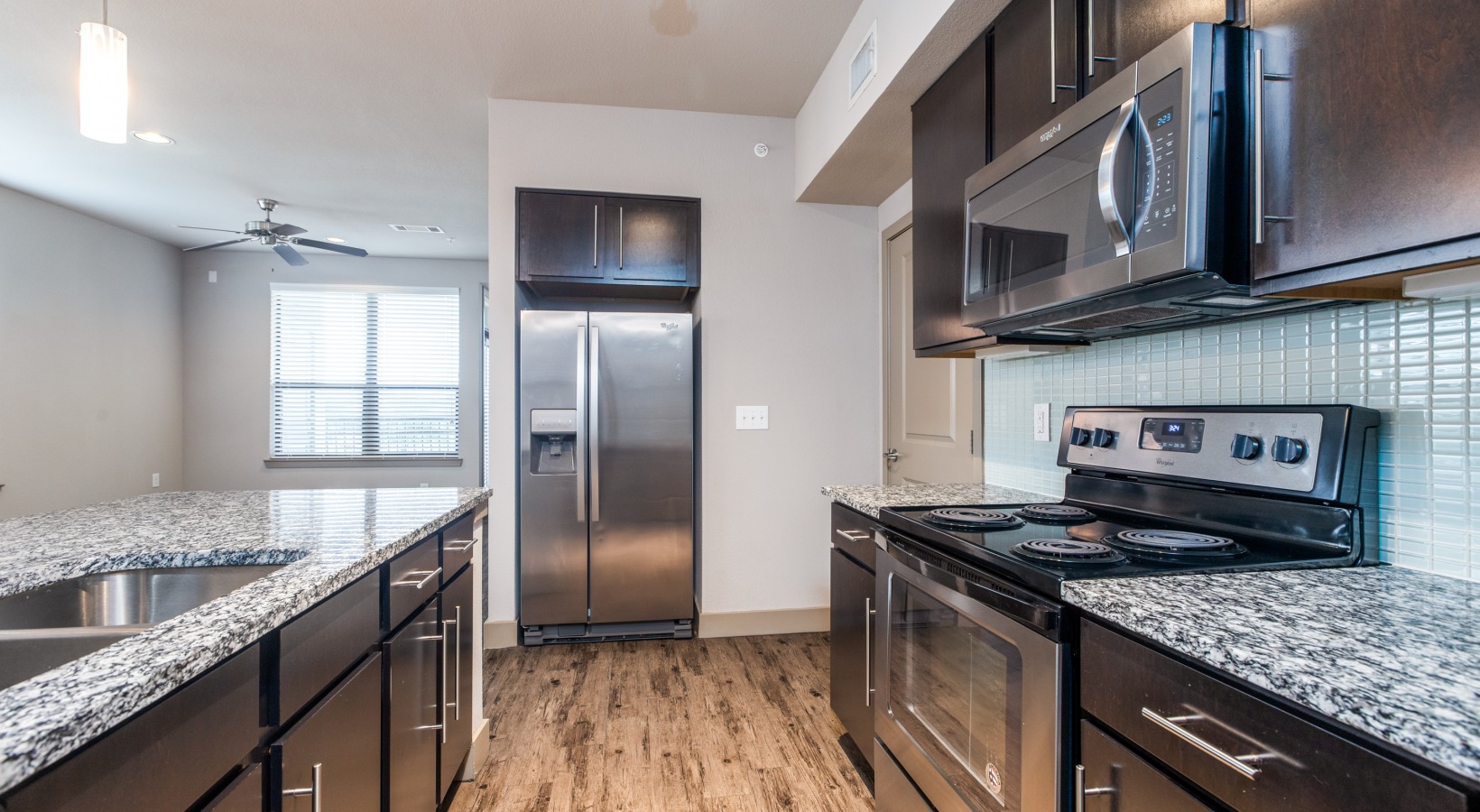 a kitchen with stainless steel appliances and granite counter tops at The  Carson @ Twin Creeks