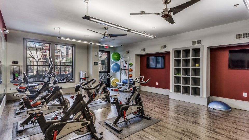 a gym room with exercise bikes and treads at The  Carson @ Twin Creeks