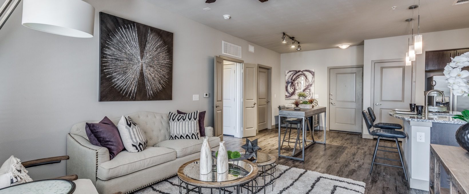 the living room has a ceiling fan and hardwood floors at The  Carson @ Twin Creeks