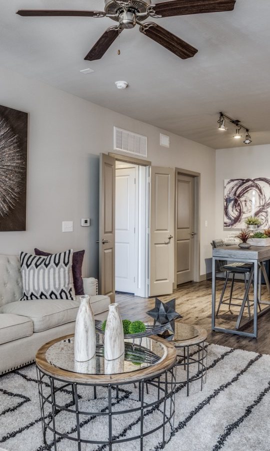 the living room has a ceiling fan and hardwood floors at The  Carson @ Twin Creeks