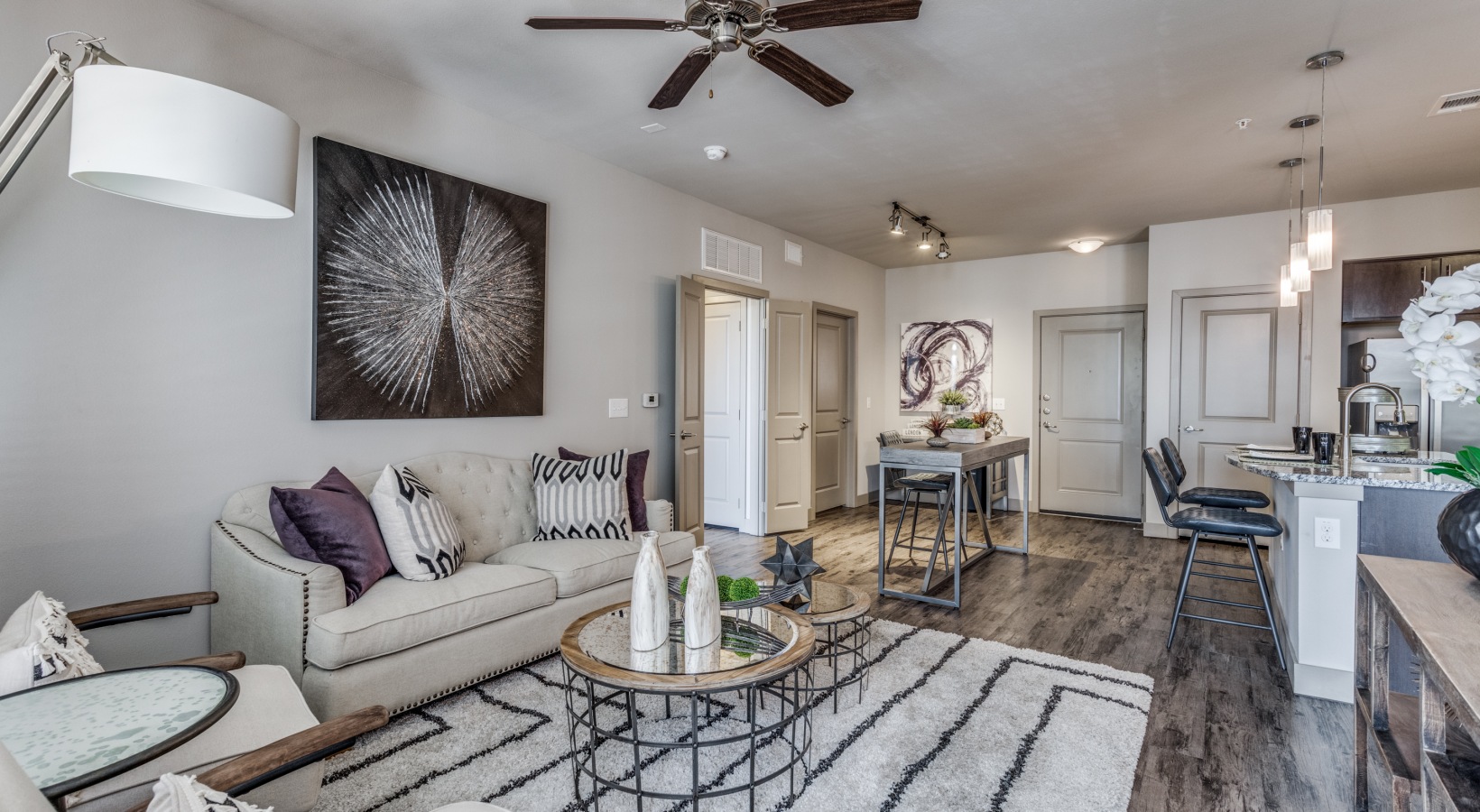 the living room has a ceiling fan and hardwood floors at The  Carson @ Twin Creeks