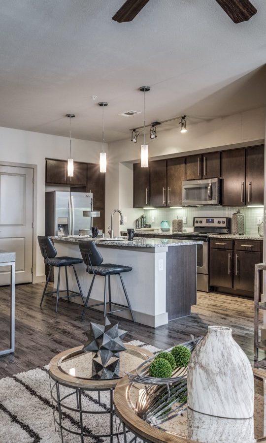 the living room and kitchen area of a home at The  Carson @ Twin Creeks