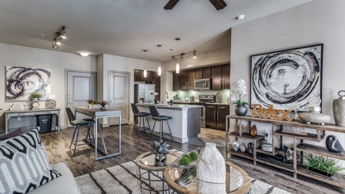 the living room and kitchen area of a home at The  Carson @ Twin Creeks