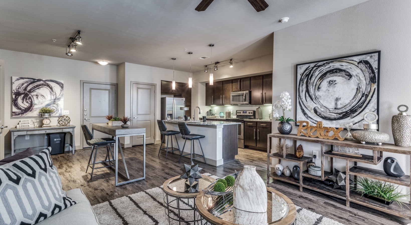 the living room and kitchen area of a home at The Carson @ Twin Creeks